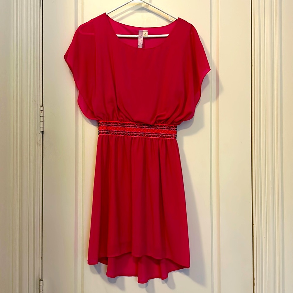 Light and airy pink beach dress with elastic waistline for dramatic look.